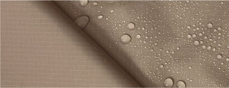 A close-up photo of a piece of a fabric with many droplets of water on it. The fabric is brown with a red stripe.